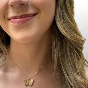 Accessorize with Athena Designs' Fly Away necklace, featuring a bronze butterfly charm that adds a playful touch to any outfit. Dance away with this dimensional accessory that's sure to turn heads.