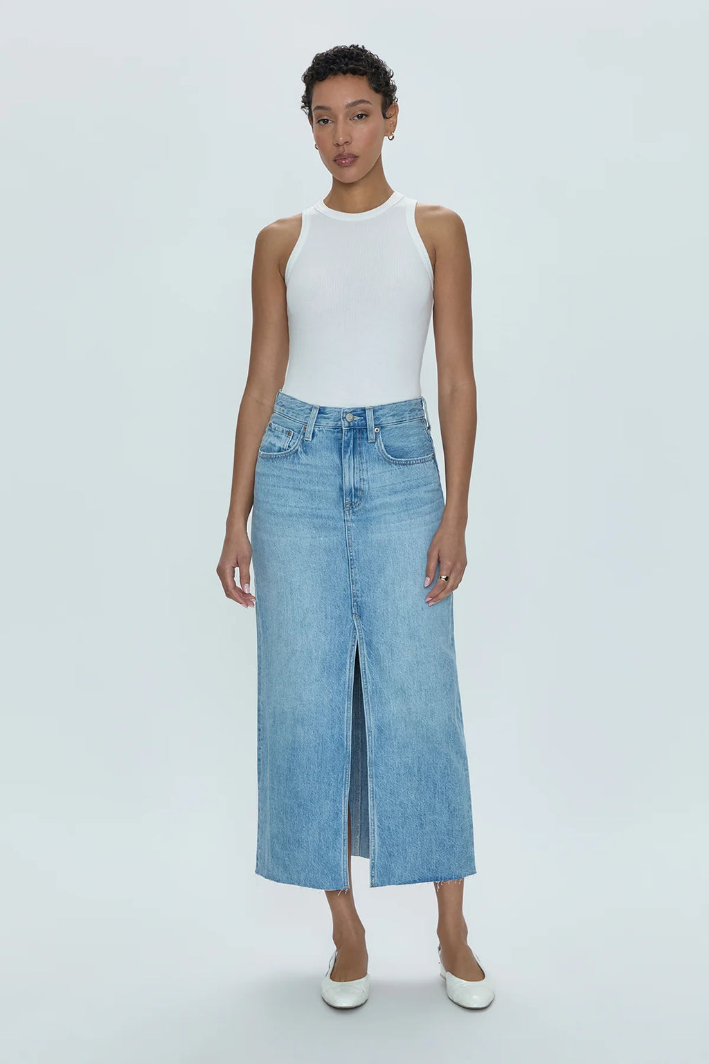 Of-the-moment, yet eternally stylish - our best selling skirt features an elongated midi length and five pocket denim design notes. Crafted from rigid denim without stretch for sophisticated fit and fall, with a well considered front skirt slit for ease of movement. Brooklyn is a clean, light wash denim with a touch of vintage inspired fading.