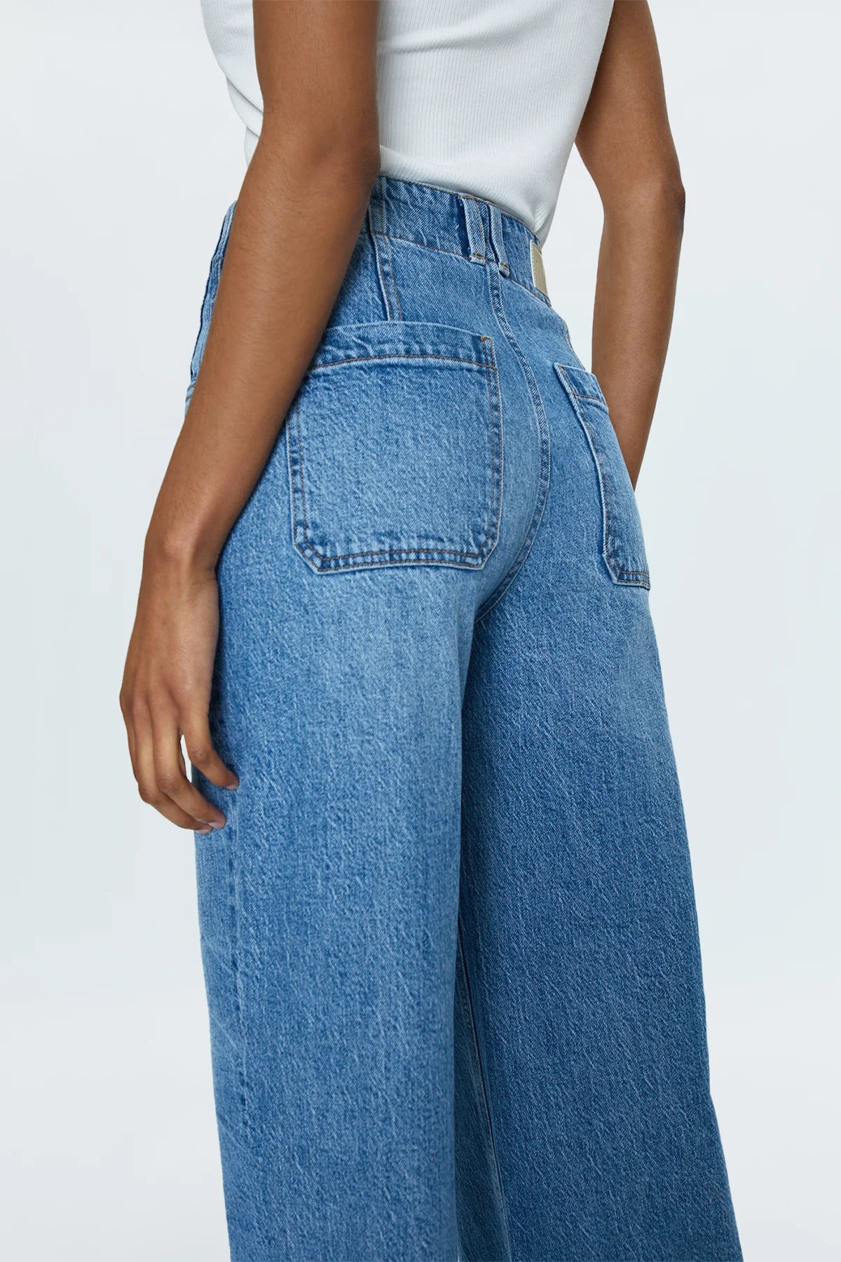 &nbsp;A relaxed, ultra wide leg silhouette with a high rise waist, breezy full length cut, and a clean finish hem. Crafted from our signature comfort stretch denim to provide a structured shape with just the right give.&nbsp;Gallery is a medium-light blue wash decorated with stacked, double waistband design detail.