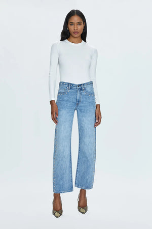 Mid-rise, with a straight leg that bows at the knees for an arched, barrel leg silhouette. Ankle length crop with a clean finish hem, crafted from rigid non-stretch denim for an expert fit that holds its shape. Satellite is a light blue denim wash with vintage fading, defined by linear stud decorations along both legs, waistband, and front pockets.