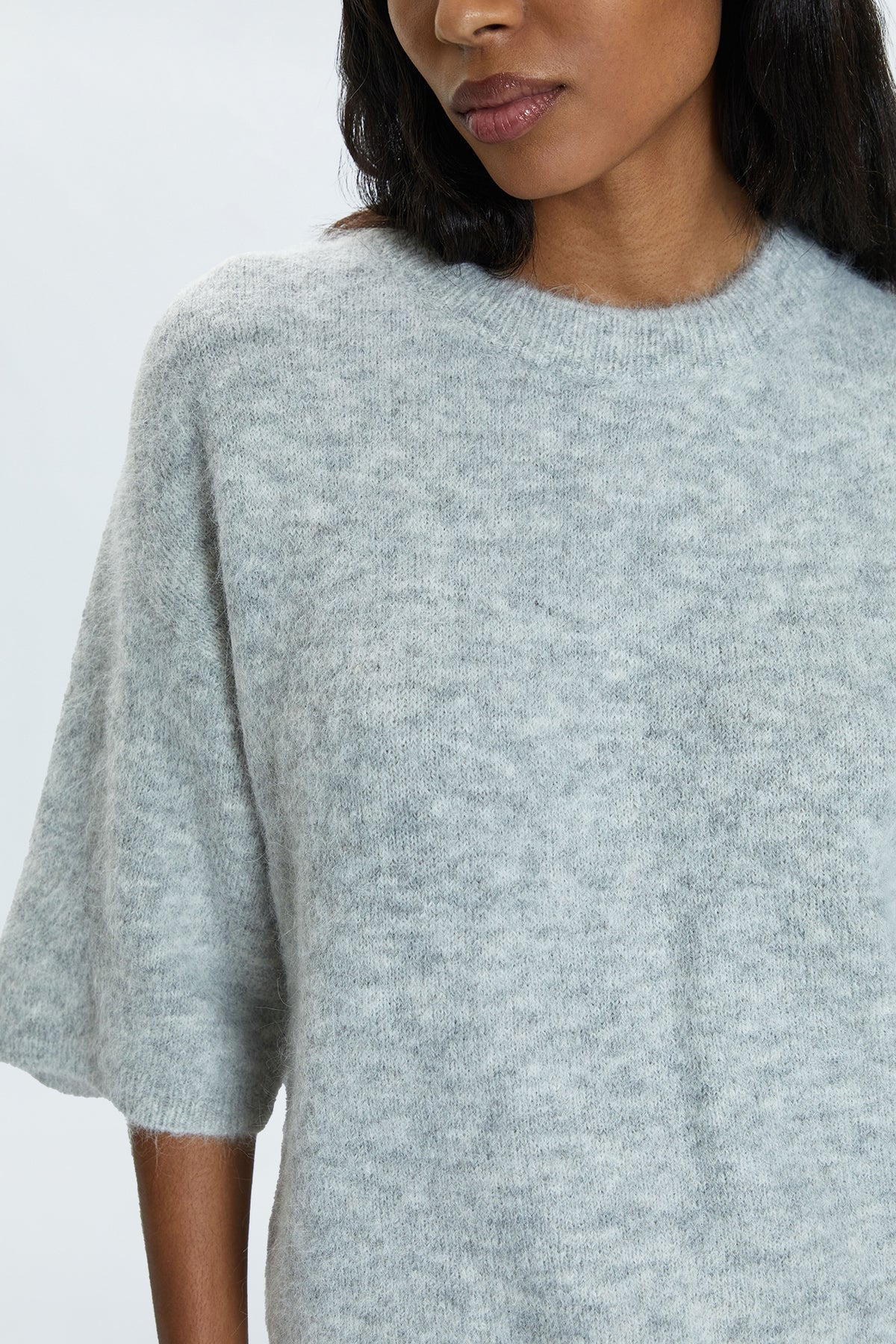 Medium weight wool knit blend with an ultra soft hand feel. Crafted into a relaxed, boxy tee silhouette with a crew neckline, dropped shoulders, and medium length half sleeves. Relaxed ribbing on sleeves, neckline, and hem. Offered in a neutral, soft grey hue.&nbsp;