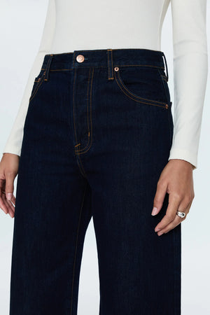 High rise waist with a relaxed, straight leg fit and an oversized cuffed ankle hem. Crafted from rigid, lightweight denim without stretch for an expert fit that holds its shape. Countdown is a deep indigo rinse wash denim with contrast stitching and copper toned hardware.&nbsp;