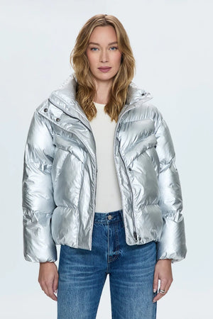 A lightweight nylon puffer jacket that hits right at the waist for a more feminine proportion. Designed with functional pocket, a collared neckline, and hidden zipper front closure. Disco is a high octane iridescent silver colorway with gunmetal hardware.