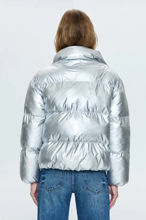 A lightweight nylon puffer jacket that hits right at the waist for a more feminine proportion. Designed with functional pocket, a collared neckline, and hidden zipper front closure. Disco is a high octane iridescent silver colorway with gunmetal hardware.