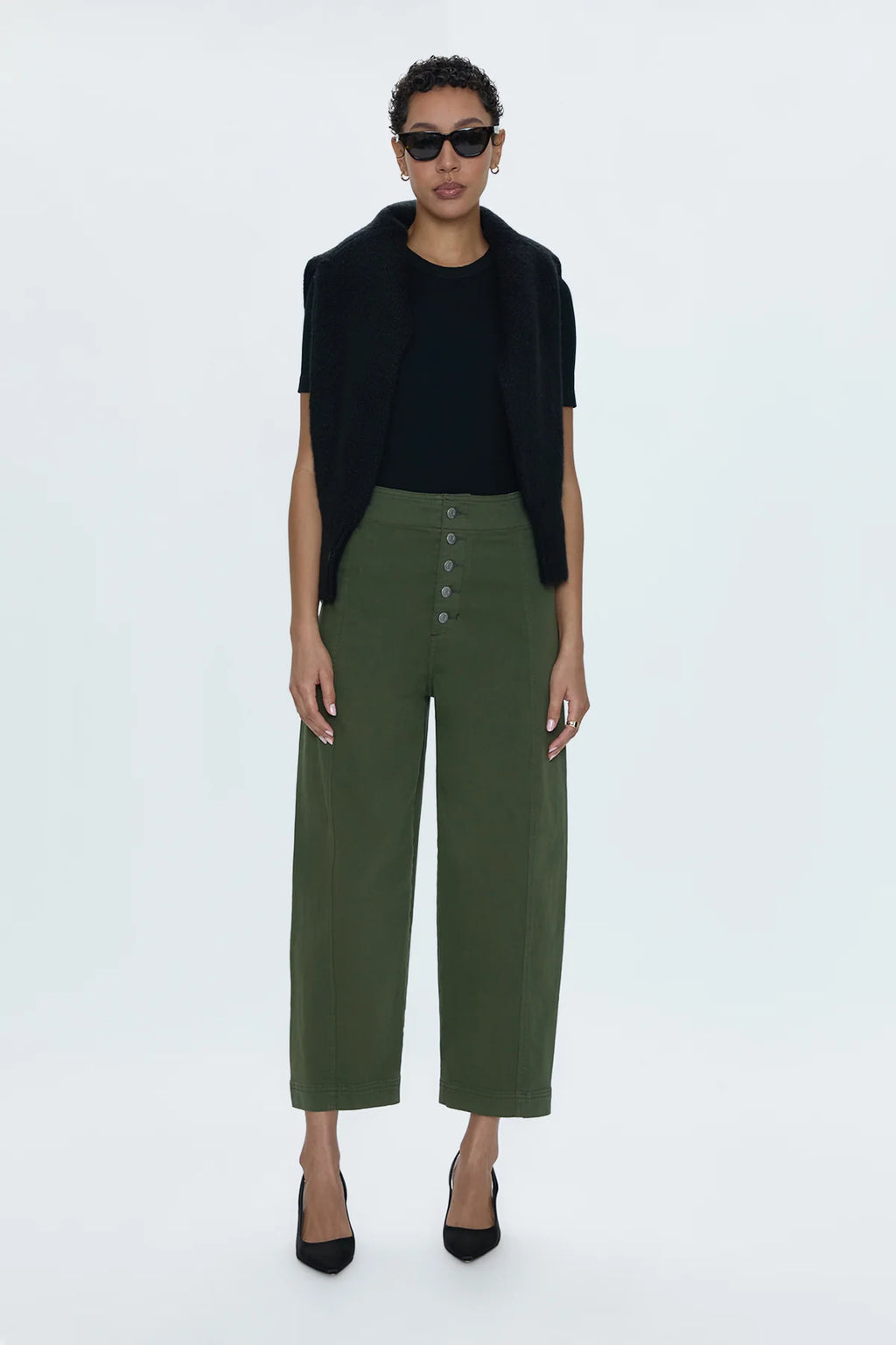 Reporting for duty. Super high waist trouser with a statement button up fly, free of front pockets for a slimming, structured fit. Double paneled legs crafted to fall into a relaxed, barrel leg silhouette that crops at the ankles. Admiral is an elevated, military green color way that doubles as a seasonal neutral for endless styling potential.