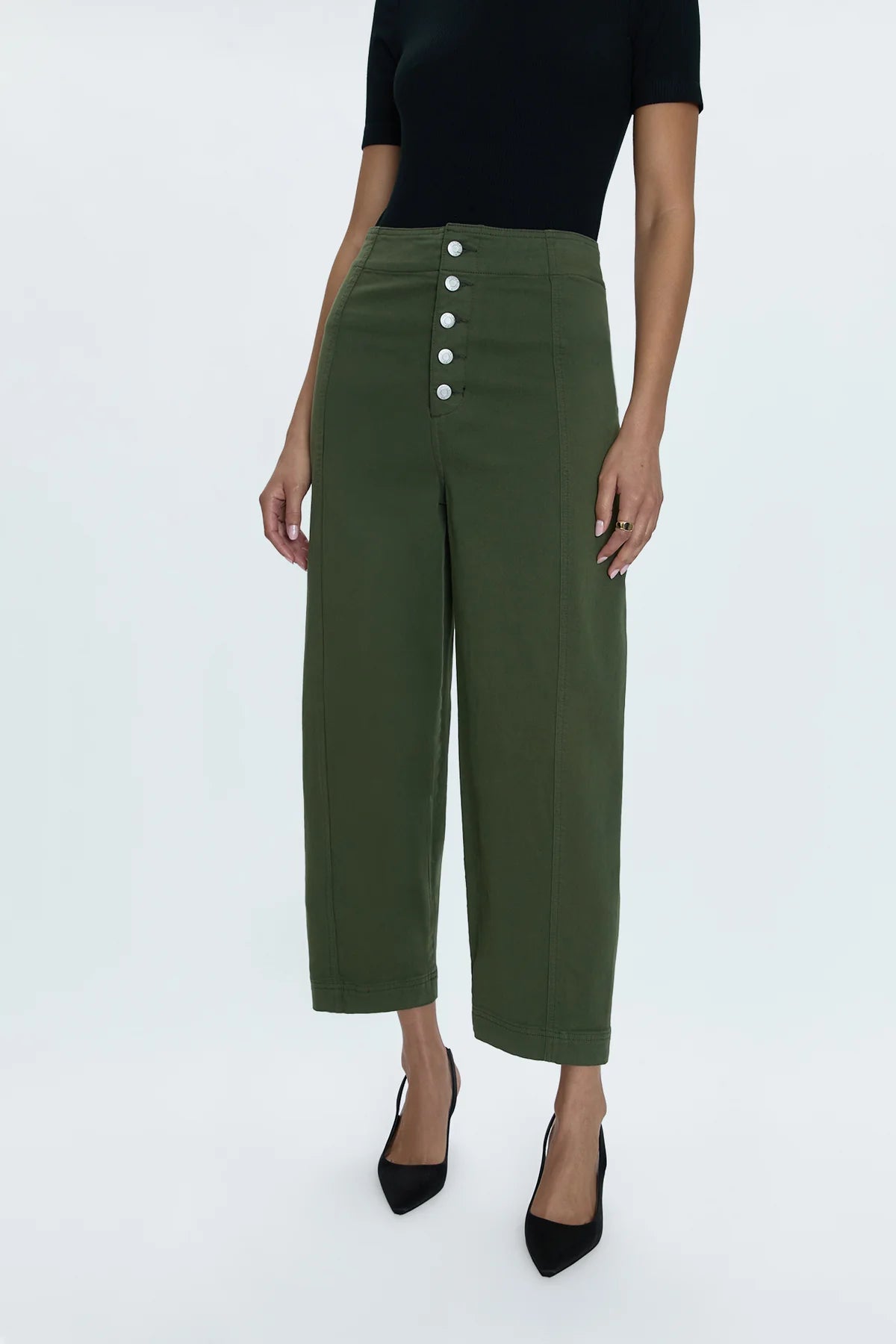 Reporting for duty. Super high waist trouser with a statement button up fly, free of front pockets for a slimming, structured fit. Double paneled legs crafted to fall into a relaxed, barrel leg silhouette that crops at the ankles. Admiral is an elevated, military green color way that doubles as a seasonal neutral for endless styling potential.