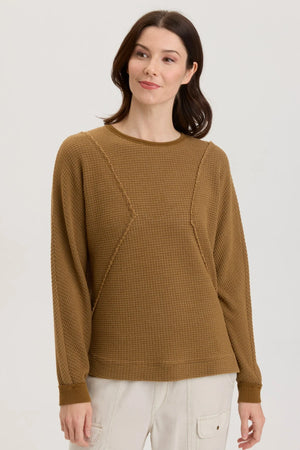 Angular seams, classic crew neck and a sweatshirt like fit with the grace of a soft thermal bring the edgy look of the Delsi Pullover to life.