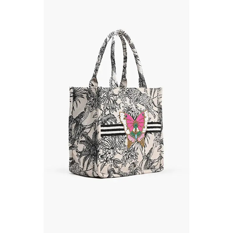 Carry your essentials in style with our whimsical Forbidden Tote! This medium-sized beauty features stunning hand-embellished beadwork and a delightful beaded butterfly that's sure to catch compliments.