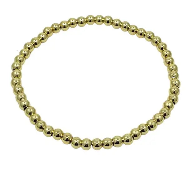 Gold beaded bracelet on a white background