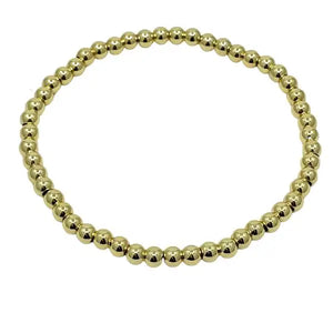 Gold beaded bracelet on a white background