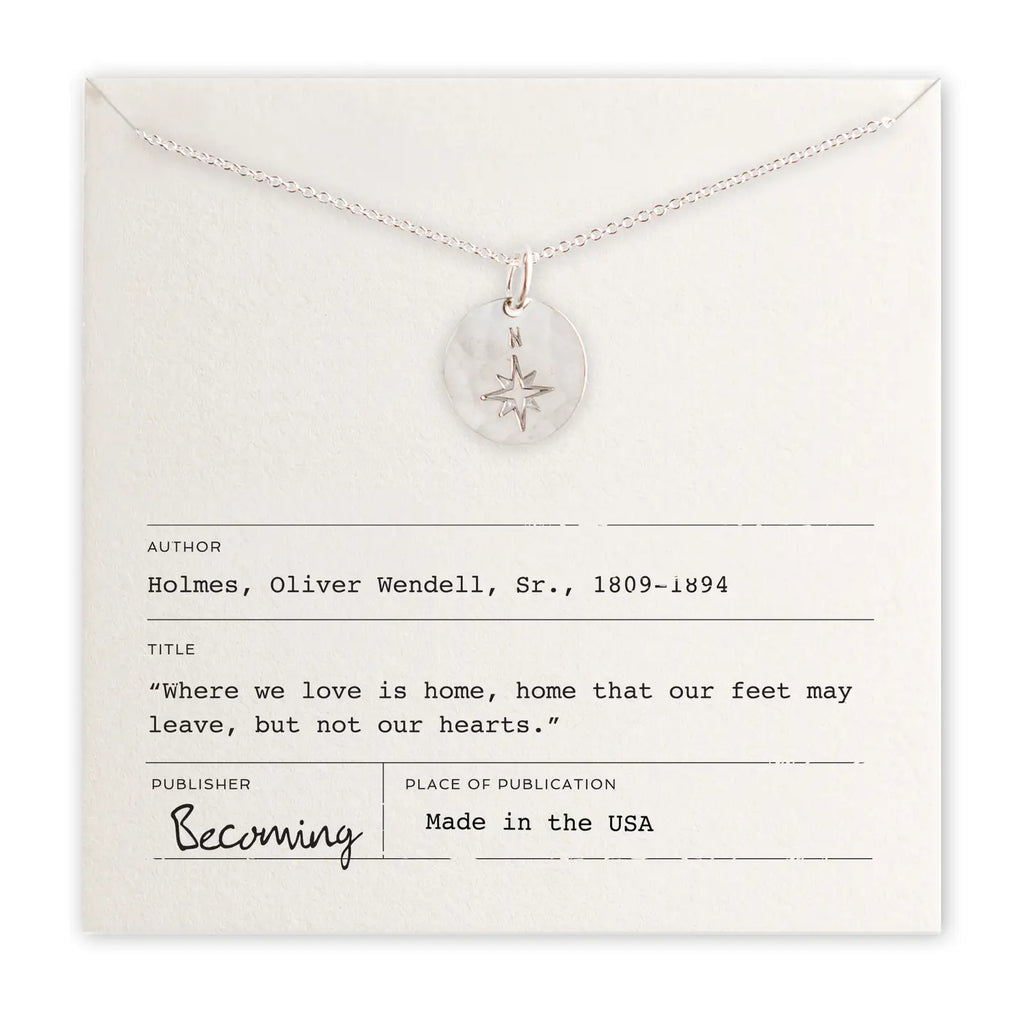 Silver necklace with a pendant on a card with text