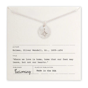 Silver necklace with a pendant on a card with text