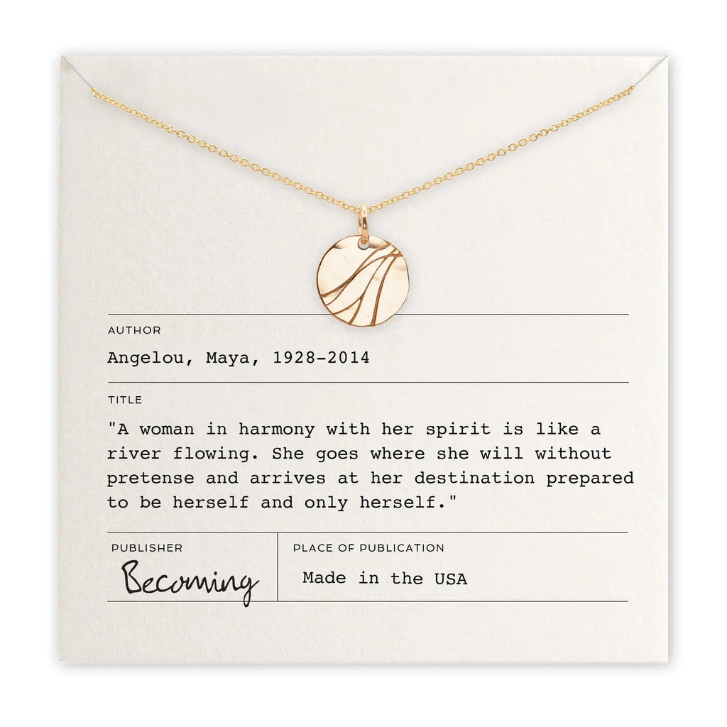 Gold necklace on a card with text and branding
