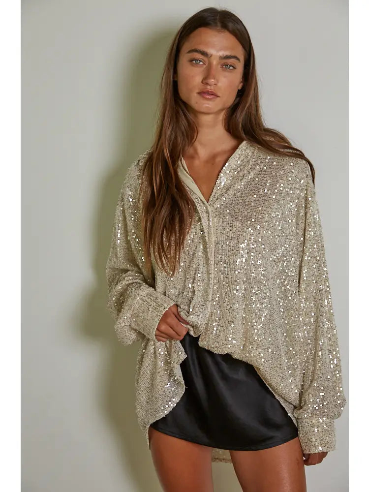 Add some glitz and glam to your wardrobe with the Colby knit tunic top by By Together. The sequin collar and long sleeves make it perfect for any occasion. Stay chic and cozy in this playful piece. (Shine bright like a sequin!)