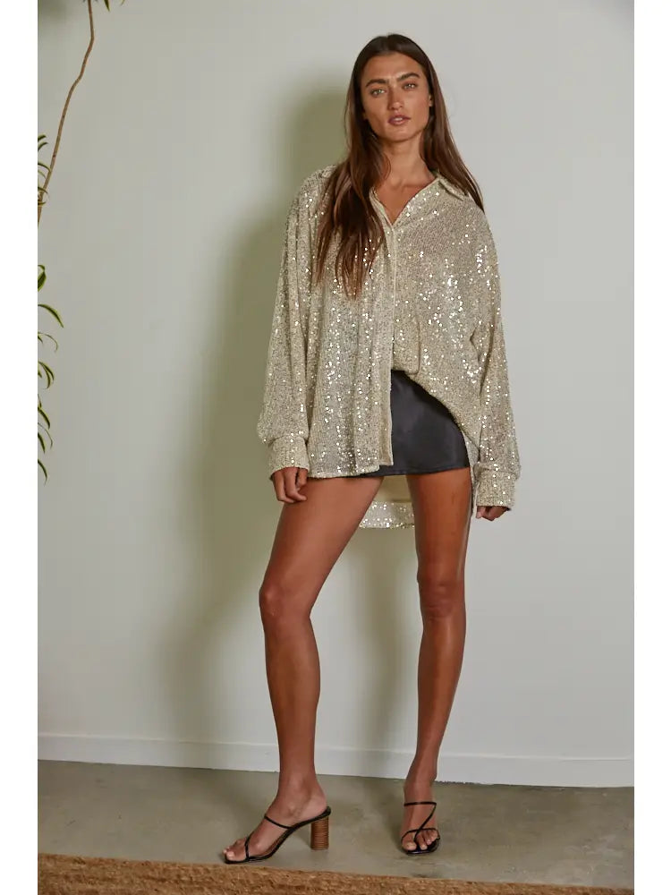 Add some glitz and glam to your wardrobe with the Colby knit tunic top by By Together. The sequin collar and long sleeves make it perfect for any occasion. Stay chic and cozy in this playful piece. (Shine bright like a sequin!)