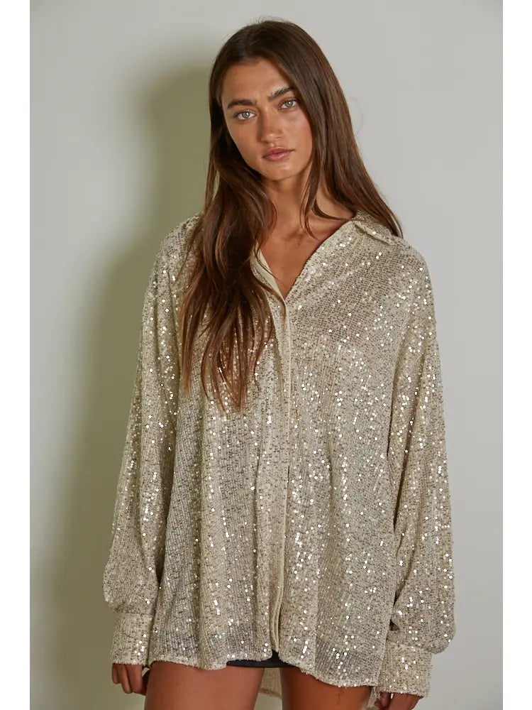 Add some glitz and glam to your wardrobe with the Colby knit tunic top by By Together. The sequin collar and long sleeves make it perfect for any occasion. Stay chic and cozy in this playful piece. (Shine bright like a sequin!)