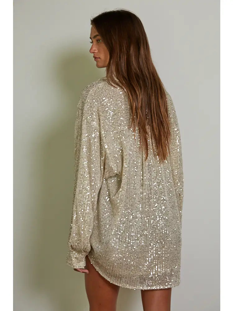 Add some glitz and glam to your wardrobe with the Colby knit tunic top by By Together. The sequin collar and long sleeves make it perfect for any occasion. Stay chic and cozy in this playful piece. (Shine bright like a sequin!)