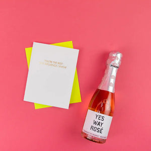 Bottle of 'YES WAY ROSE' with a card on a pink background