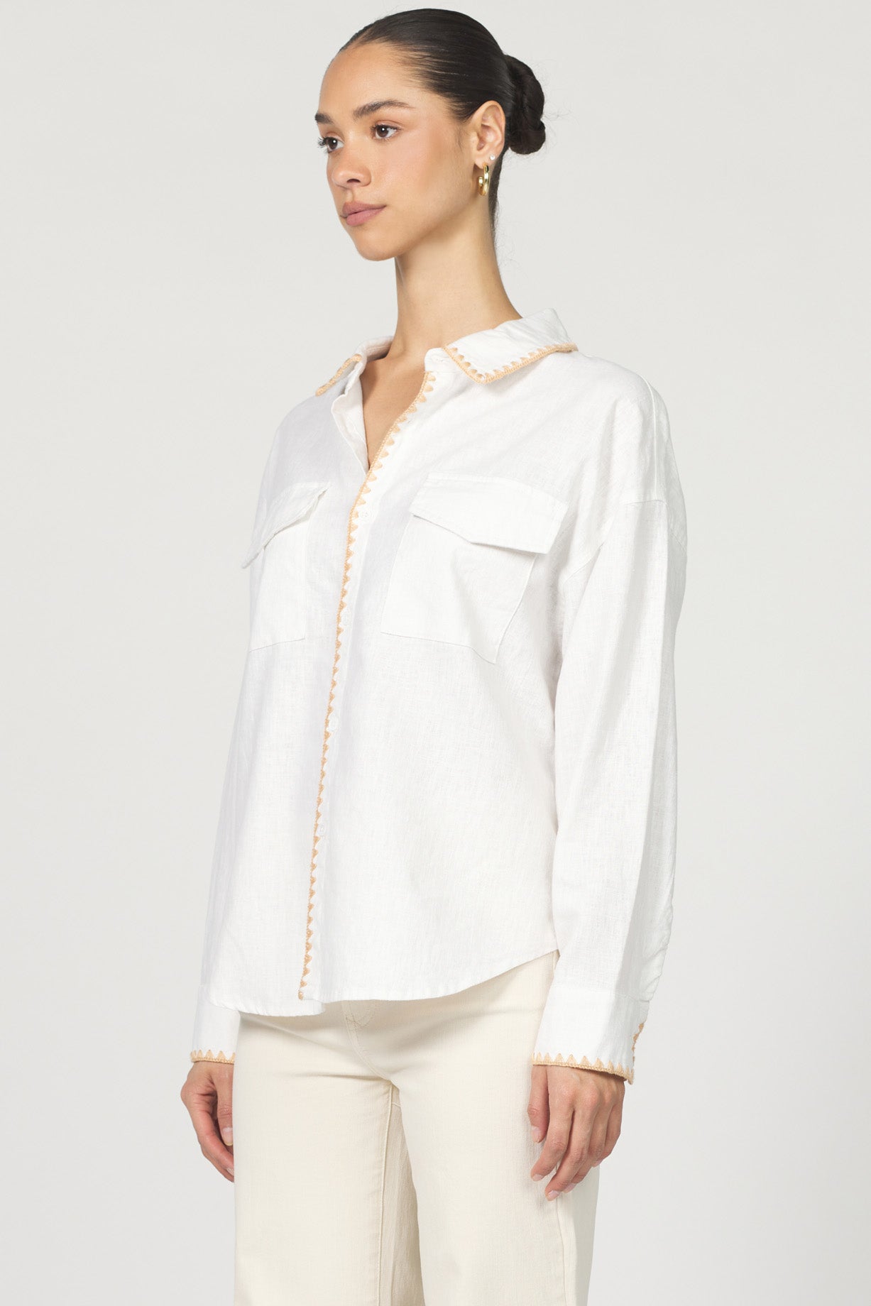 Wrap yourself in casual charm with the Dear John Adrianna button-up! This long sleeve beauty features eye-catching blanket stitching that adds a playful pop to your everyday wardrobe.