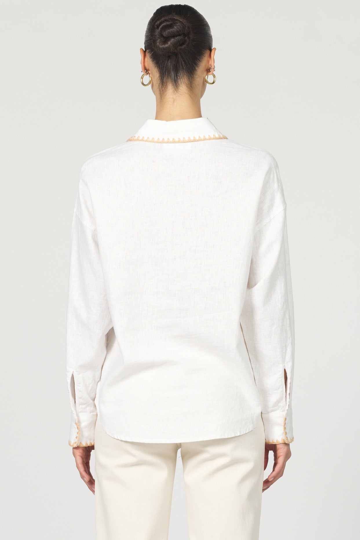 Wrap yourself in casual charm with the Dear John Adrianna button-up! This long sleeve beauty features eye-catching blanket stitching that adds a playful pop to your everyday wardrobe.