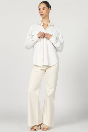 Wrap yourself in casual charm with the Dear John Adrianna button-up! This long sleeve beauty features eye-catching blanket stitching that adds a playful pop to your everyday wardrobe.