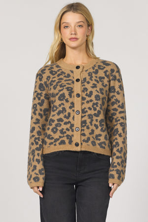 Woman wearing a leopard print cardigan on a plain background