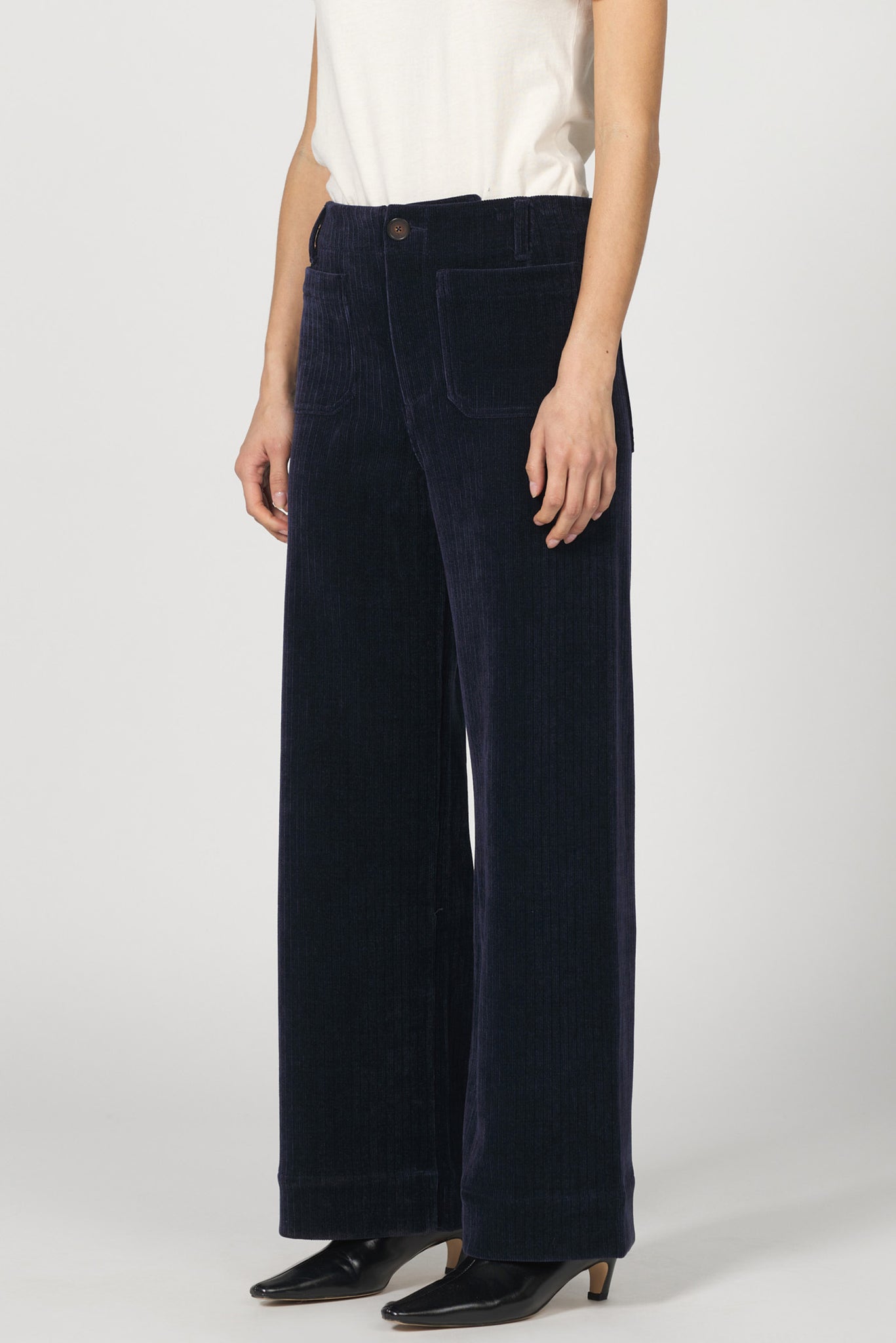 Navy wide-leg pants worn by a person on a white background