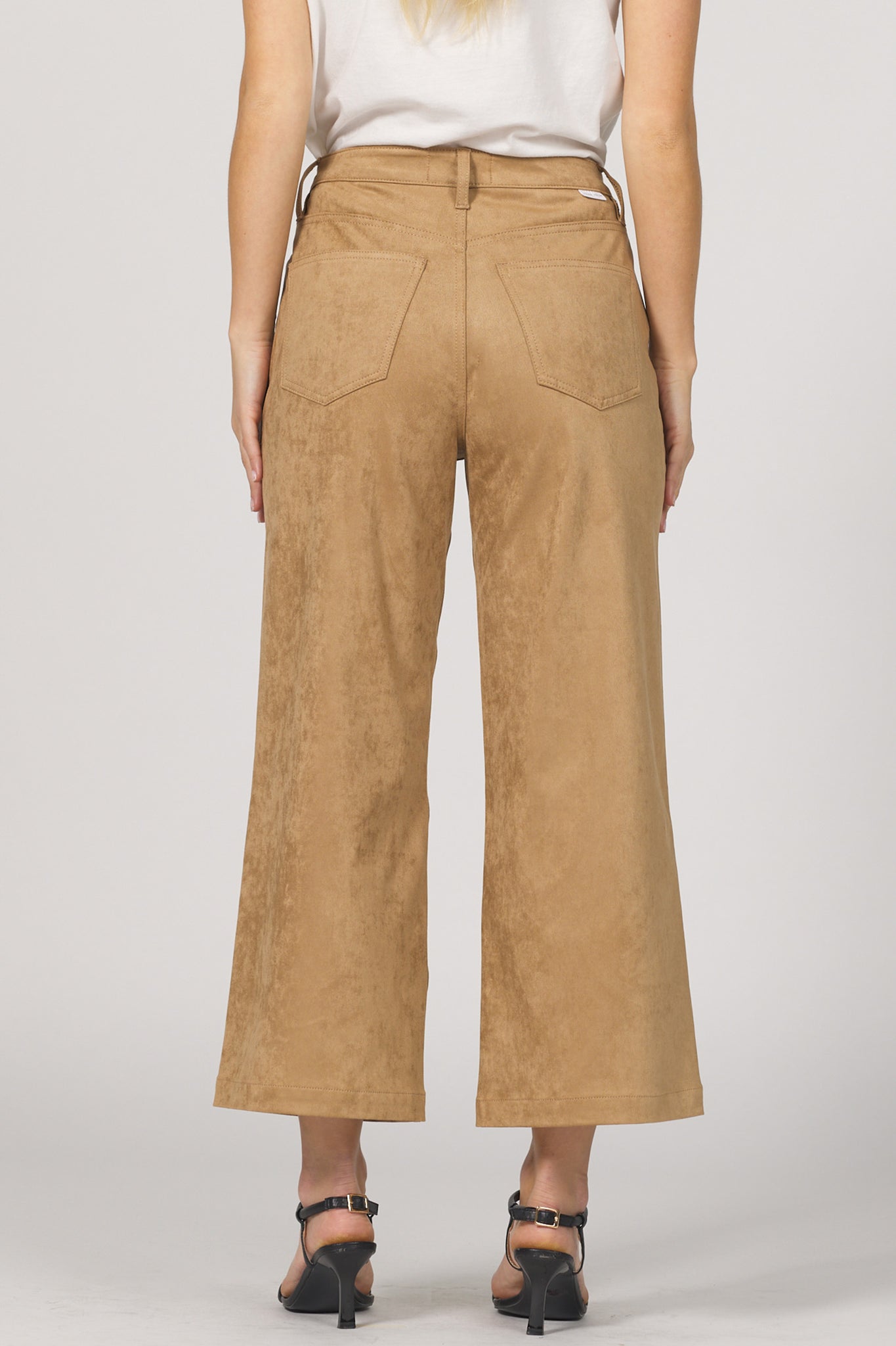 Tan wide-leg pants worn by a person on a plain background