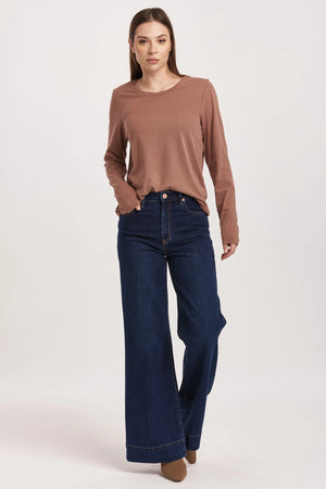 High rise wide leg jeans. It's cozy fit that sits at natural waist, embraces your natural curves and accentuates your hips and thigh. Full inseam on stretch denim accented with wide hem cuff, tailor pressed seam lines, cut-off hem details, washed in rich indigo shade.