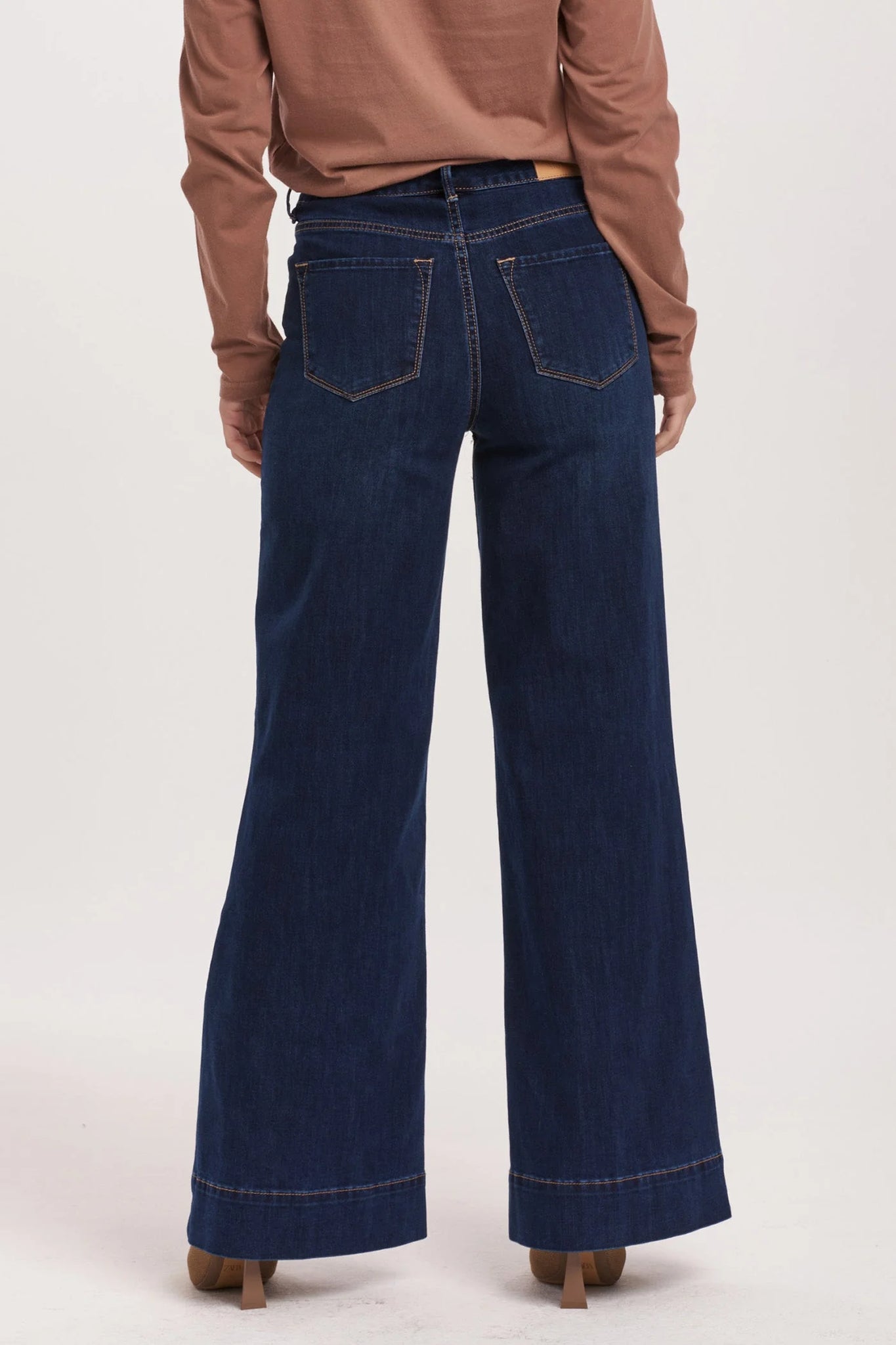 High rise wide leg jeans. It's cozy fit that sits at natural waist, embraces your natural curves and accentuates your hips and thigh. Full inseam on stretch denim accented with wide hem cuff, tailor pressed seam lines, cut-off hem details, washed in rich indigo shade.