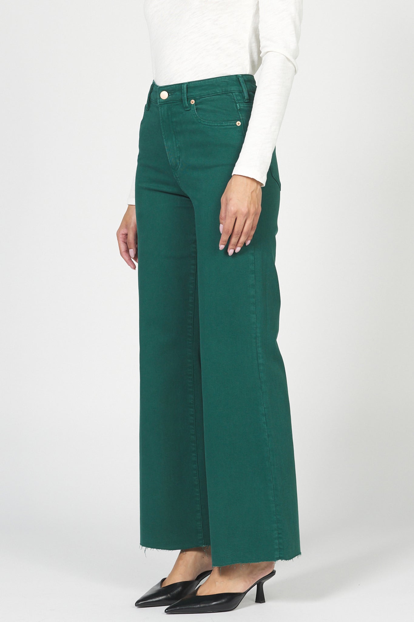 Green wide-leg jeans worn by a person on a white background