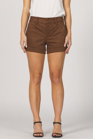 Brown shorts worn by a person on a white background