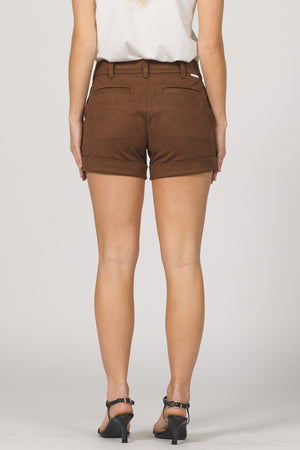 Brown shorts worn by a person on a plain background
