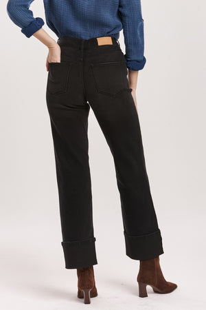 Person wearing black pants and a blue shirt on a white background