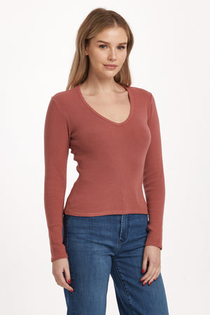 Get ready to rock the v-neck long fitted sleeve top from Dear John's Marlowe collection. This top is perfect for a night out or a casual day in. Embrace your curves with the fitted silhouette and show off your playful side with the v-neckline. (Warning: may cause compliments.)