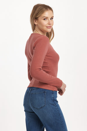 Get ready to rock the v-neck long fitted sleeve top from Dear John's Marlowe collection. This top is perfect for a night out or a casual day in. Embrace your curves with the fitted silhouette and show off your playful side with the v-neckline. (Warning: may cause compliments.)