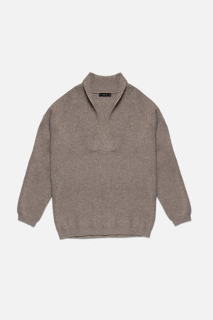 Brown sweater on a light beige background