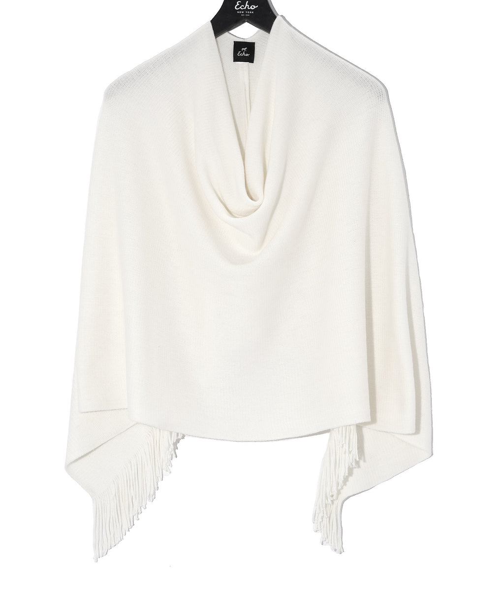 This poncho has a secret ingredient. Made with milk (yes, milk!) fiber, the result is unbelievably soft to the touch, cozy enough for those chilly evenings, and lightweight enough to wear every day. The asymmetrical hem and fringe trim provide the finish touch for a piece that's sure to become your fall staple.