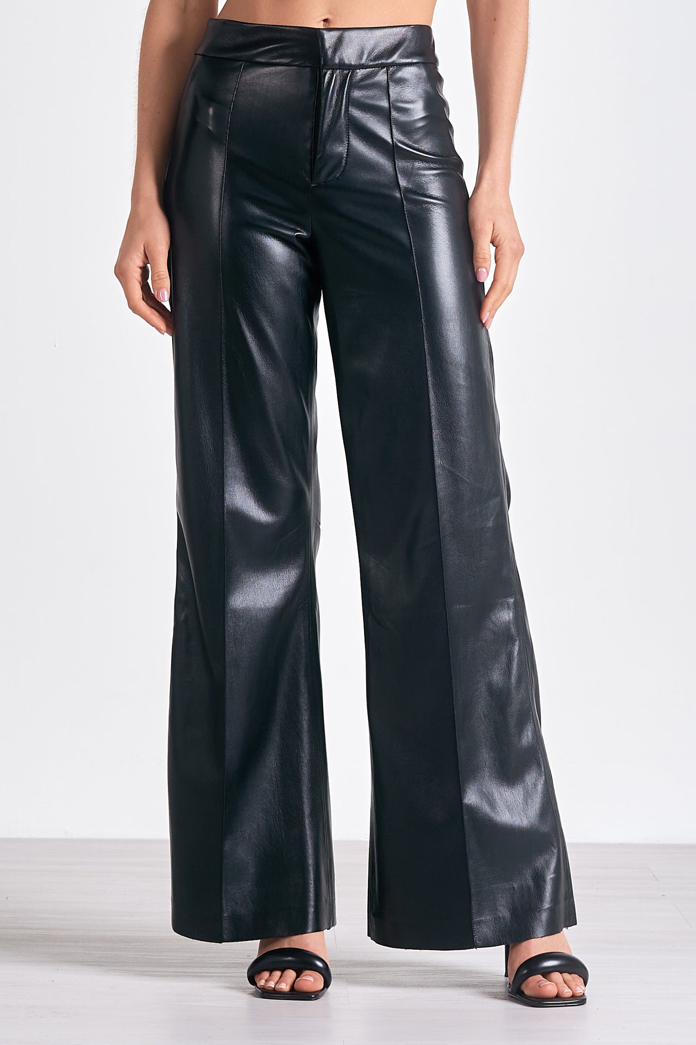 Unleash your inner fashionista with Elan's Paris high waisted flair leg faux leather pant. These statement-making pants not only elongate your legs, but also add a touch of edgy style to your wardrobe. Rock them day or night for a bold and confident look. (Channel your inner Parisian!)