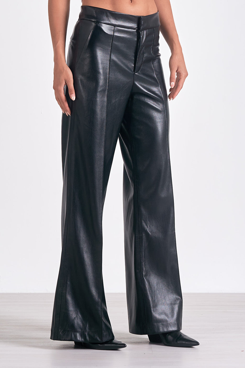 Unleash your inner fashionista with Elan's Paris high waisted flair leg faux leather pant. These statement-making pants not only elongate your legs, but also add a touch of edgy style to your wardrobe. Rock them day or night for a bold and confident look. (Channel your inner Parisian!)