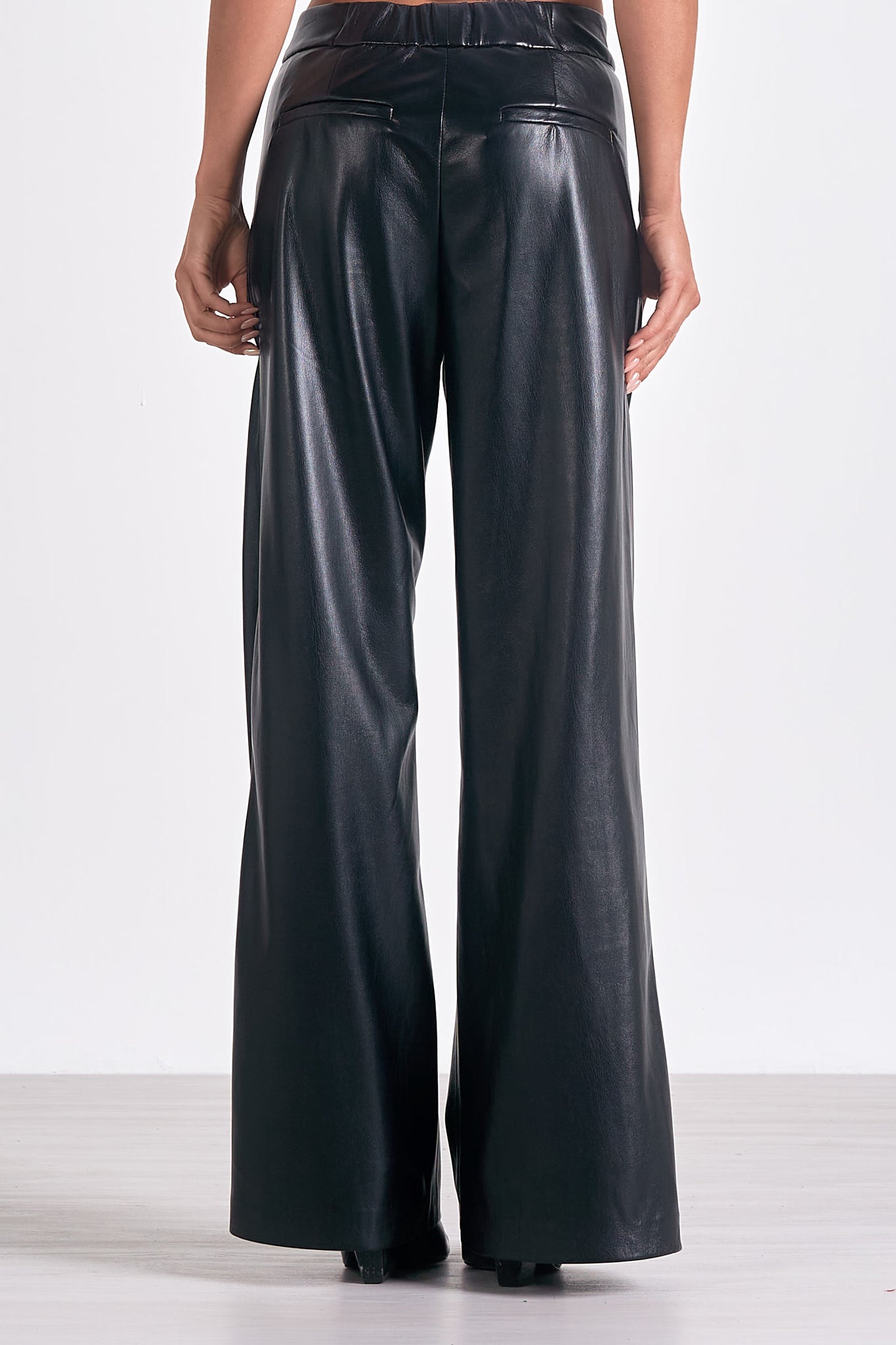 Unleash your inner fashionista with Elan's Paris high waisted flair leg faux leather pant. These statement-making pants not only elongate your legs, but also add a touch of edgy style to your wardrobe. Rock them day or night for a bold and confident look. (Channel your inner Parisian!)