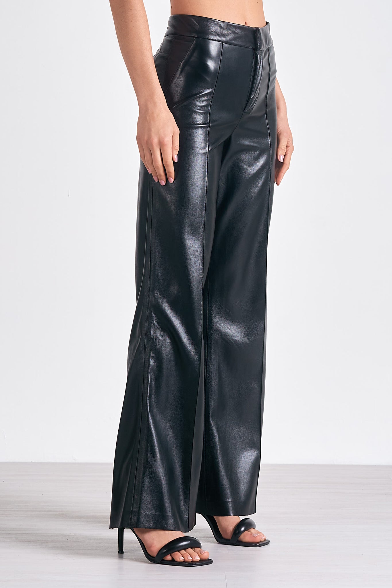 Unleash your inner fashionista with Elan's Paris high waisted flair leg faux leather pant. These statement-making pants not only elongate your legs, but also add a touch of edgy style to your wardrobe. Rock them day or night for a bold and confident look. (Channel your inner Parisian!)