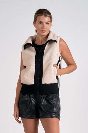 The Elan Manitoba vest is faux sherling at its finest. Stay warm and stylish with this cozy vest that will make you feel like a true fashionista. Bundle up in comfort and turn heads with its unique design. Perfect for any outfit, any occasion, and any personality. (Seriously, why wouldn't you want this?)