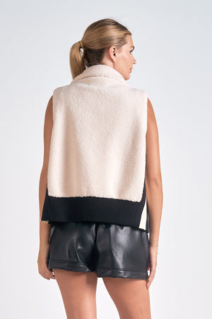 The Elan Manitoba vest is faux sherling at its finest. Stay warm and stylish with this cozy vest that will make you feel like a true fashionista. Bundle up in comfort and turn heads with its unique design. Perfect for any outfit, any occasion, and any personality. (Seriously, why wouldn't you want this?)