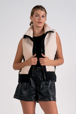 The Elan Manitoba vest is faux sherling at its finest. Stay warm and stylish with this cozy vest that will make you feel like a true fashionista. Bundle up in comfort and turn heads with its unique design. Perfect for any outfit, any occasion, and any personality. (Seriously, why wouldn't you want this?)