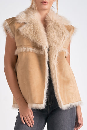 Take your style to new heights with our Elan Telluride vest. This long faux fur vest adds a playful touch to any outfit. Stay cozy while turning heads with this unique piece. Step up your fashion game with Elan Telluride.