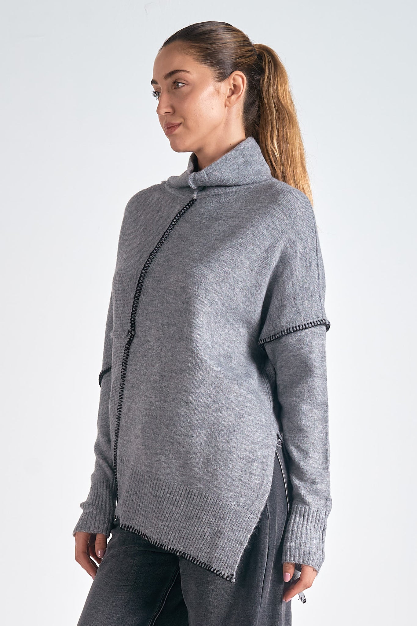 Stay warm and stylish with the Vanilla Sweater. The jumbo turtleneck offers superior warmth, while the asymmetrical design and contrast stitching add a touch of uniqueness. Whether paired with jeans or skirts, the Vanilla Sweater provides cozy comfort without compromising on style.