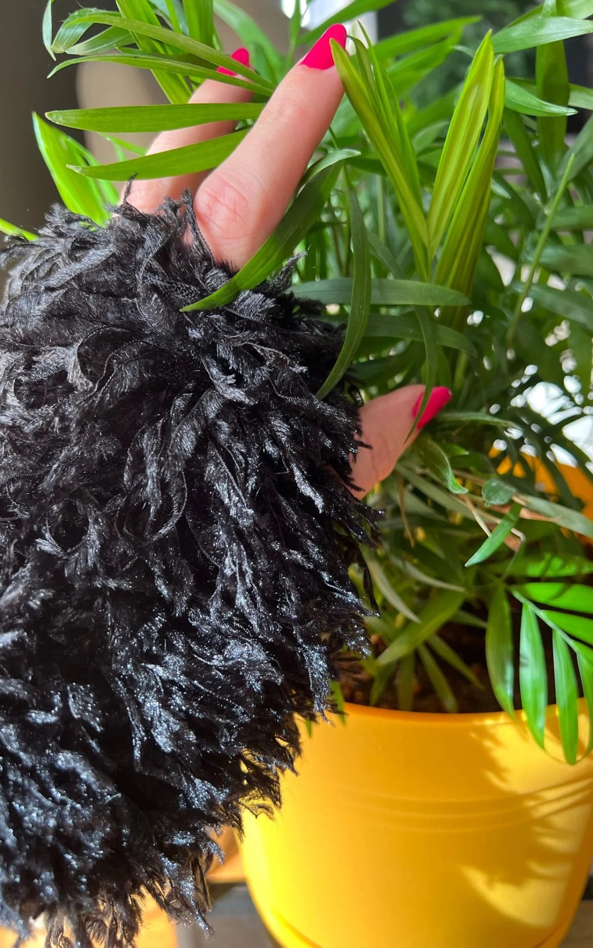 A great, faux fur, cozy hand-warmer.Shown in Black Swan Faux Feather, lined in Cuddly Faux Fur in Black.