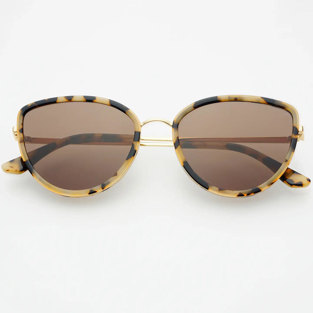 Sunglasses with gold frame and tortoiseshell accents on a white background