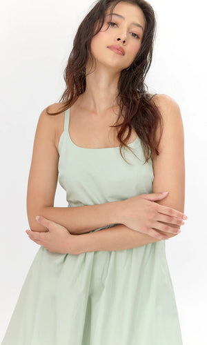This midi dress is defined by it's bold and playful bubble skirt. The structure showcases hidden pockets, a smocked back, and a square neckline.